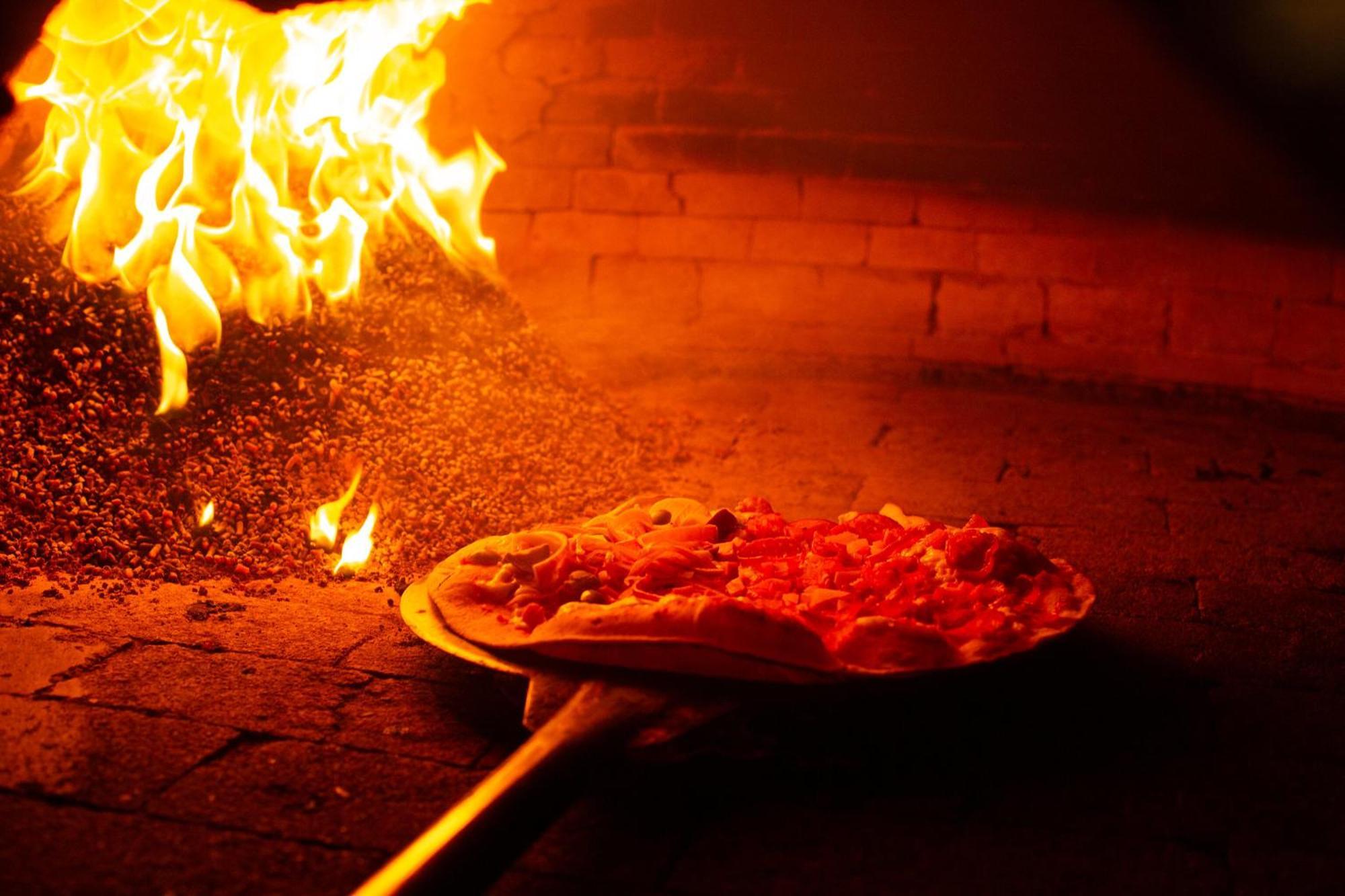 Costao Do Santinho Resort All Inclusive Флорианополис Экстерьер фото Pizza being cooked in a wood-fired oven